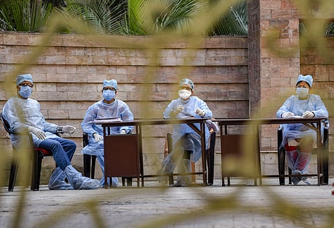 Medics at a residential complex to take blood samples. (Photo | PTI)