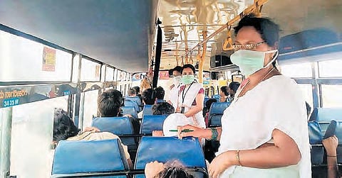 A primary healthcare team checks passengers for COVID-19 symptoms at the Chiragpally checkpost, near the Maharashtra border.
