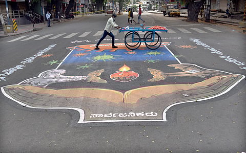 A vendor pushes his cart on a deserted street in Bengaluru. (Photo | Nagaraja Gadekal, EPS)