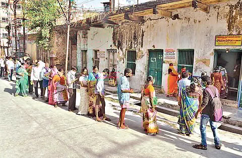 People waiting in a queue to collect ration in front of a fair price shop. (File photo | EPS)