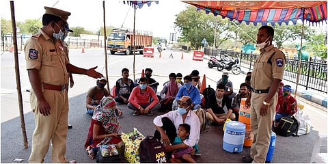 Police talk to migrants workers going home on foot in Hyderabad. (Photo |  S Senbagapandiyan, EPS)