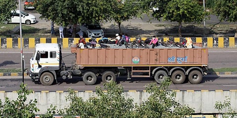 Migrants traveling on a truck to go to their native place during coronavirus lockdown, in Lucknow. (Photo| ANI)