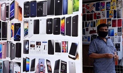 A mobile phone store owner awaits a customer or two amid COVID-19 lockdown in Chennai's T Nagar.