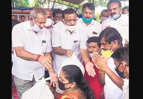 Minister Byrati Basavaraj distributes food kits at NTI Grounds in Vidyaranyapura. (Photo | EPS)