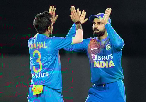 Indian captain Virat Kohli high fives Yuzvendra Chahal after he caught New Zealand's Kane Williamson out. (Photo | AP)