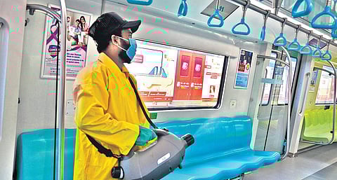 A worker disinfecting a Kochi Metro train coach on Monday | Express