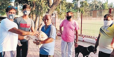 On Sunday, Yashasvi Jaiswal (second from left) and coach Jwala Singh (left) donated rations to groundsmen and staff who are employed at Air India Sports Club, Mumbai.