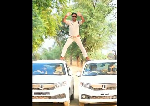 WATCH | 'Singham' stunt gone wrong? Mandya Pradesh cop fined for balancing self on two moving cars