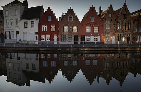 Houses make a reflection on the water in Bruges, Belgium, during a partial lifting of a lockdown to prevent the spread of coronavirus.(Photo | AP)