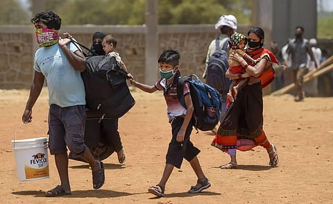 Migrants arrive to board buses departing for railway terminus from where they will board trains to travel to their native places during the ongoing nationwide COVID-19 lockdown at Wadala in Mumbai. (Photo | PTI)