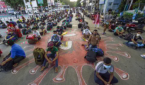 Migrants waiting in a queue to board trains to Assam and Meghalaya from Central Railway Station during the ongoing nationwide COVID-19 lockdown in Chennai Wednesday May 13 2020. (Photo | PTI)