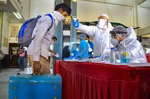 Migrant labourers being screened by medics on their arrival at Habibganj railway station from Panvel Maharashtra by a special train amid ongoing COVID-19 lockdown in Bhopal Thursday May 7 2020. (Photo | PTI)