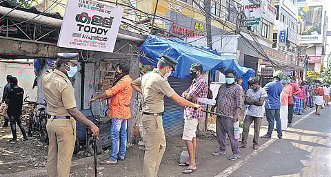 Tipplers awaiting their turn in front of a toddy shop at Kaloor in Kochi. Long queues were seen at toddy outlets across the state | A Sanesh