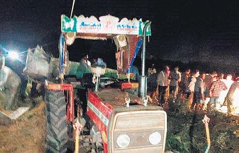 High-tension electric wires snap and fall on a tractor carrying agriculture labourers, at Machavaram village in Prakasam district on Thursday | Express
