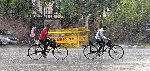 Commuters ride bicycles during a spell of heavyrain in New Delhi on Thursday. (Photo| Parveen Negi, EPS)