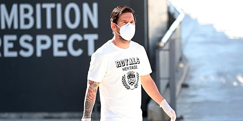 In this photo provided by FC Barcelona, Lionel Messi walks wearing a protective face mask at the club's training ground. (Photo | AP)