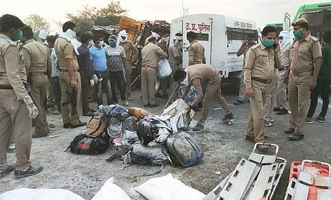 Police officials inspect the spot where atleast 24 migrants were killed and 36 injured after a trailer truck carrying labourers collided with a DCM van in wee hours, at Mihauli in Auraiya district. (Photo | PTI)