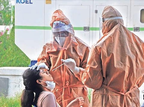 Swab samples being collected from a foreign returnee in Vijayawada  on Sunday I Prasant Madugula
