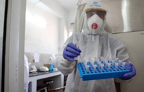A medic arranges tubes after collecting swab samples for COVID-19 tests (Photo | PTI)