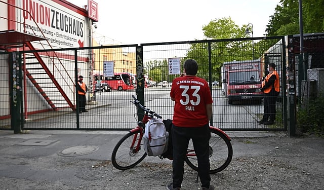 A Bayern Munich supporter stands at the closed entrance to the Stadion An der Alten Foersterei during the Bundesliga match between FC Union Berlin and Bayern on Monday. Fans are not allowed to enter stadiums anymore due to the COVID-19 pandemic. (Photo | AP)