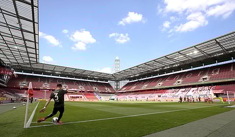 Aaron of FSV Mainz 05 takes a corner kick during the German Bundesliga match against 1. FC Cologne in Cologne. Set-pieces taken closer to the stands are usually marked by vibrant roars of the fans. Social distancing protocols means only the players' voice echoed in the otherwise packed galleries of Germany. (Photo | AP)