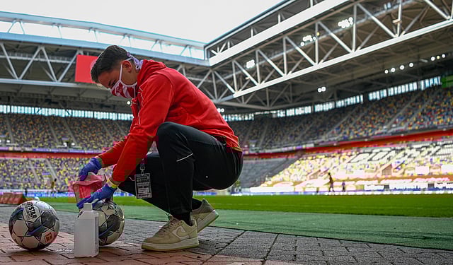 Footballs are disinfected during a Bundesliga match. (Photo | AP)