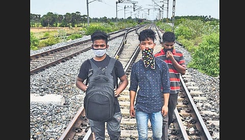 A group of migrant workers from Assam walking on rail tracks along NH-16 as police stop those who are walking or cycling towards their home States | Shiba Prasad Sahu