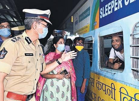 DGP Gautam Sawang interacts with migrants leaving in a Shramik special at Rayanapadu railway station on Sunday night | Express