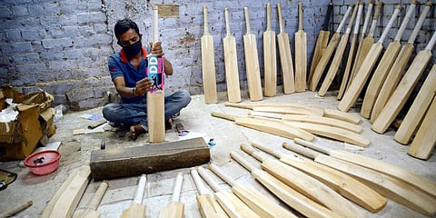 A worker prepares cricket bats at Dixon sports Factory as sports industry work resume, during the lockdown, in Jalandhar. (Photo| ANI)
