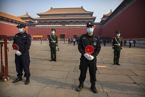 Chinese paramilitary police and security officers wear face masks to protect against the spread of the new coronavirus. (Photo | AP)