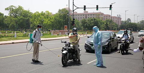 Police personnel wearing PPE suit checking the documents of a commuter in New Delhi. This image is used for representational purposes. (Photo |  Shekhar Yadav, EPS)