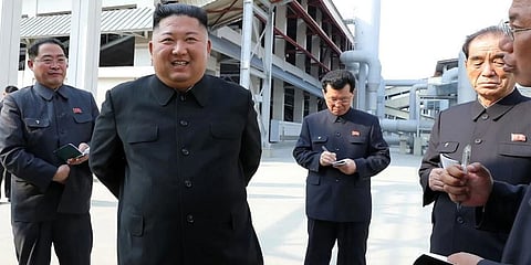 North Korean leader Kim Jong-un (second from left) visits a fertiliser factory in North Korea, in a photograph released on Saturday. (Photo | AFP)