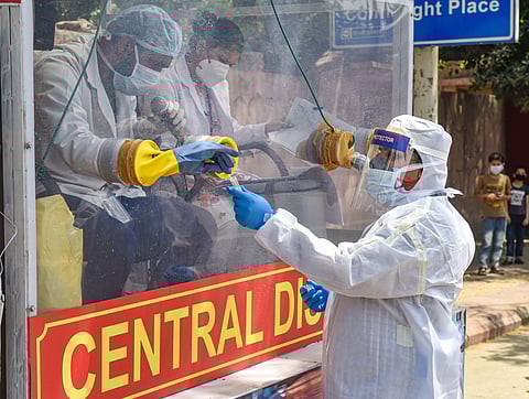 Medics prepare to collect samples for swab tests from a COVID-19 mobile testing van, during the nationwide lockdown to curb the spread of coronavirus. (Photo | PTI)