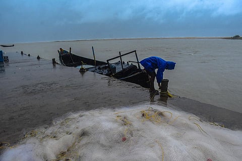 A man anchoring a boat as heavy wind flowing ahead of cyclone Amphan landfall in Balasore district. (Photo | Biswananth Swain, EPS)