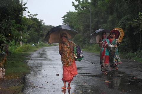 People with their belongings on their way to a cyclone shelter home in Balasore district.(Photo | Biswananth Swain, EPS)