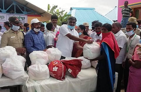 Tamil Nadu Minister KC Veeramani distributing the relief material