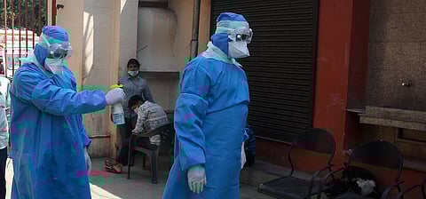 Health workers wear protective gear sanitize their body during the nation wide lockdown in New Delhi on Saturday. (Photo | Shekhar Yadav, EPS)