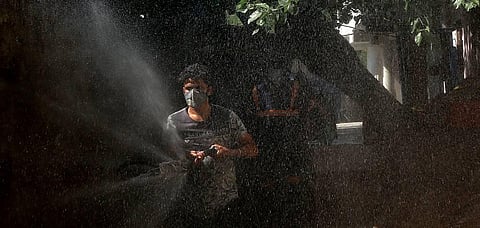 A municipal worker sprays disinfectant at residential area during the ongoing COVID-19 nationwide lockdown in New Delhi on Wednesday. (Photo | Shekhar Yadav, EPS)