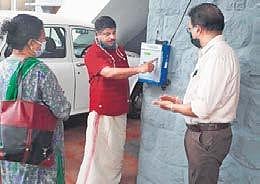 District panchayat member, Razi receiving the first token from the smart queue management device. Dr Prem Jain, chief veterinary officer, looks on