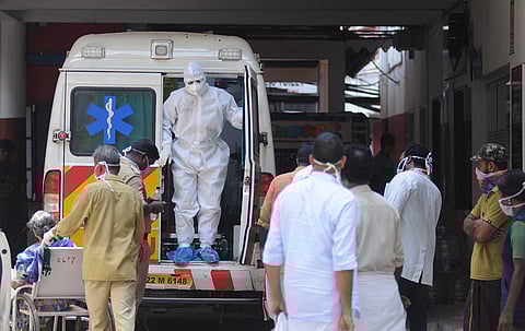 An MCH official coming out of the ambulance which carried a patient to the general hospital in Kochi.(Photo | A Sanesh, EPS)