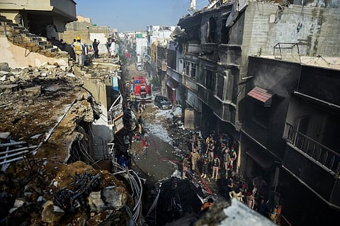A Pakistani plane with nearly 100 people on board crashed into a residential area in the southern city of Karachi on May 22. (Photo | AFP)