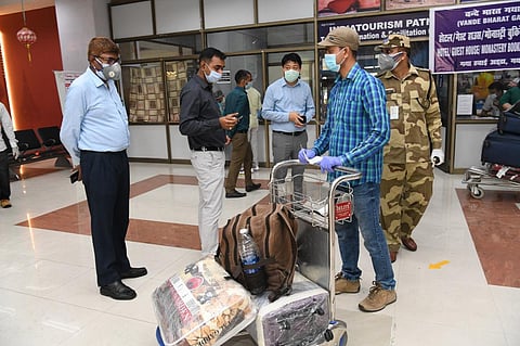 Passengers undergoing screening process at Bodh Gaya Airport upon their return from Muscat on Sunday. (Photo | Express)