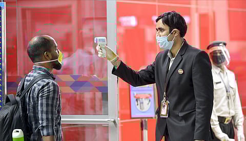 A passenger gets thermal scanned as he arrives at T-3 airport for domestic travel after flights were resumed in New Delhi Monday May 25 2020. (Photo | PTI)