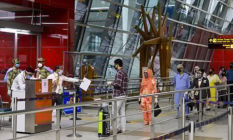 Passengers stand in a queue as they arrive at T-3 airport for domestic travel after flights resumed in New Delhi Monday May 25 2020. (Photo | PTI)