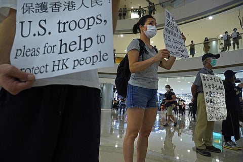 Protester display placards in a shopping mall during a protest against China's proposed tough national security legislation for the city in Hong Kong. (Photo | AP)