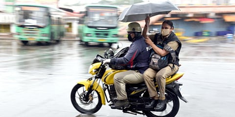 Police on duty during the heavy rains which lashed Bengaluru on Sunday. (Photo| Nagaraja Gadekal, EPS)