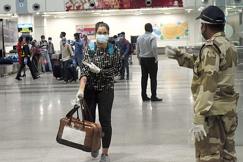A woman passenger shows her stamped hand as she exits Bhubaneswar airport after arriving from Bengaluru. (Photo | Biswanath Swain, EPS)