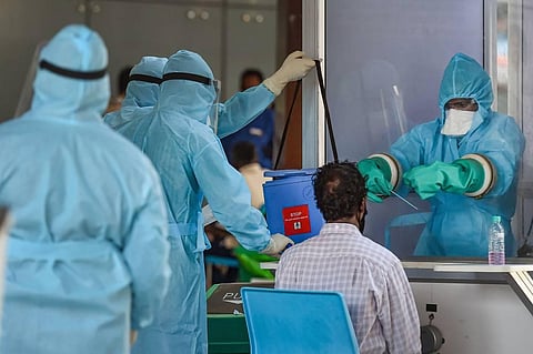 A medic takes samples from an Indian national arriving from Myanmar at Anna International Airport during the ongoing COVID-19 nationwide lockdown in Chennai. (Photo | PTI)