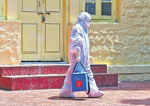 A doctor in a PPE suit comes out of Victoria Hospital on Tuesday | SHRIRAM B N