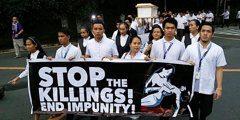 Seminarians and nuns carry slogans and a mock coffin during a rally in Manila, Philippines, against drug-related killings. (File Photo | AP)